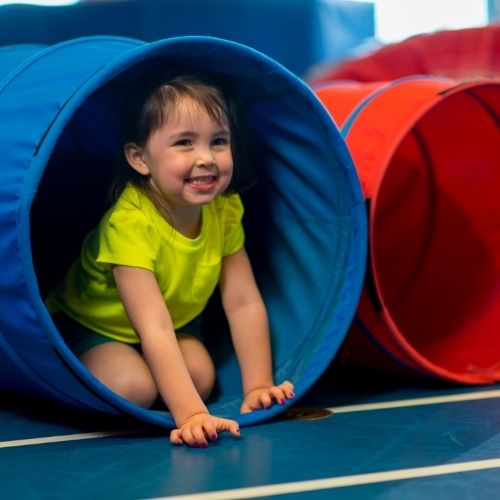 toddler playing in crawl tunnel