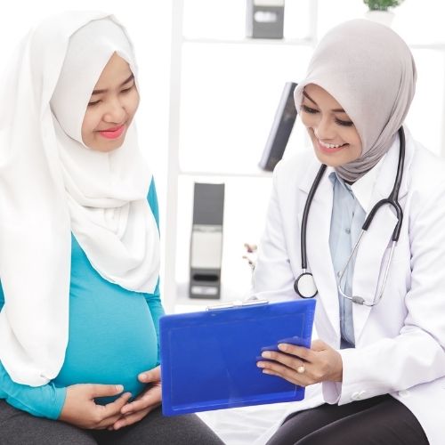 doctor obstetrician midwife with pregnant woman