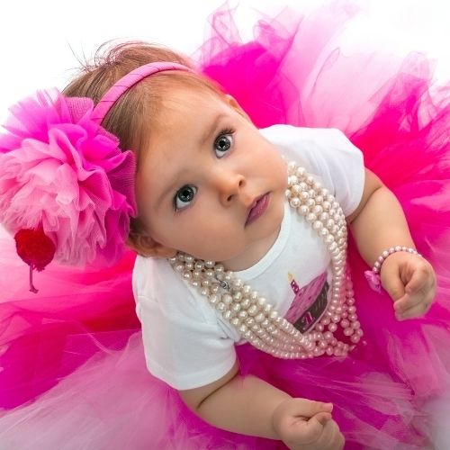 little girl with pink tutu wearing pearls