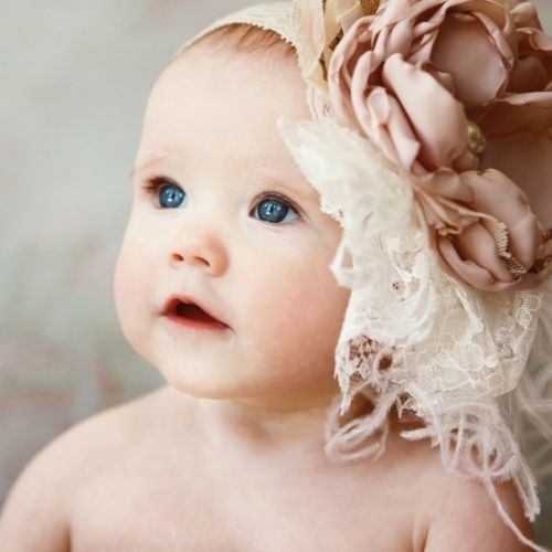 little girl wearing large vintage flower headband