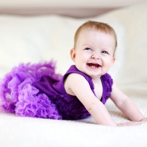 baby girl in purple dress