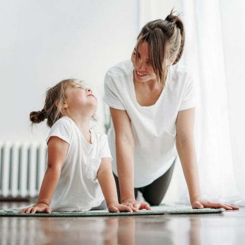 mom stretching with daughter