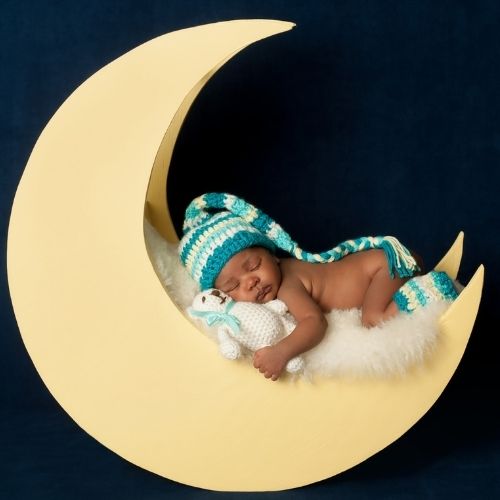 baby sleeping in moon