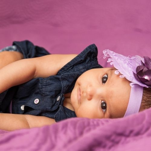 baby girl princess in headband wearing purple