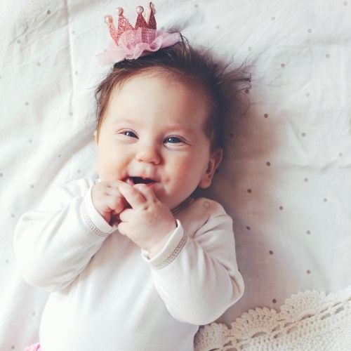 baby girl smiling wearing crown