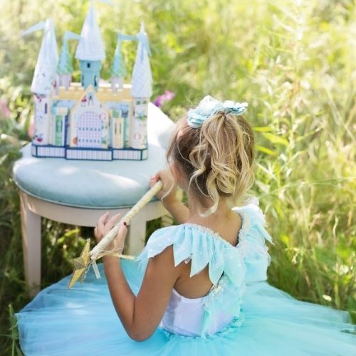 baby girl with castle and crown in blue dress