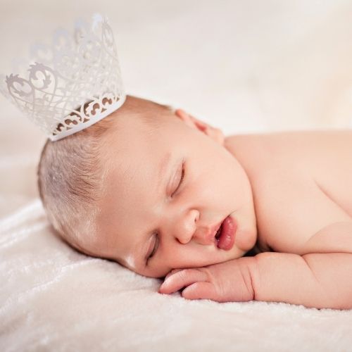 baby girl sleeping wearing a small crown