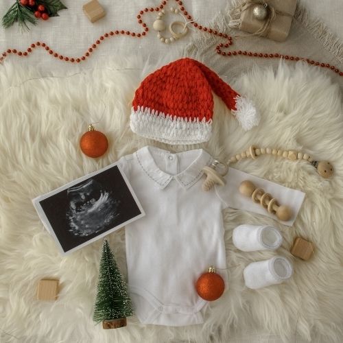 onesie and ultrasound photo with santa hat 