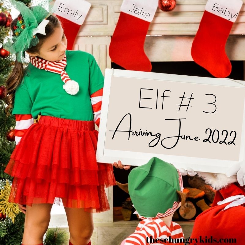 kids dressed as santa's elves holding sign announcing pregnancy