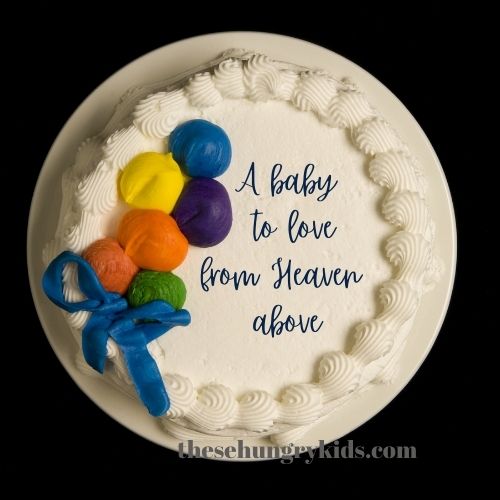 white baby shower cake saying "a baby to love from heaven above"