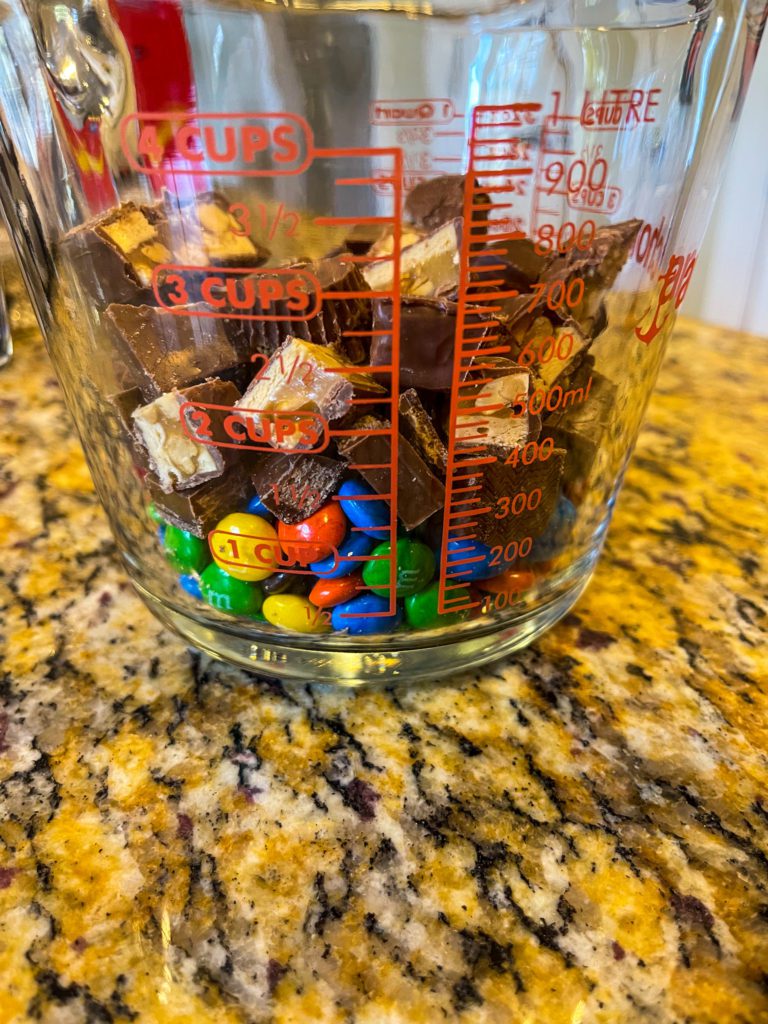 chopped candy bars in measuring cup