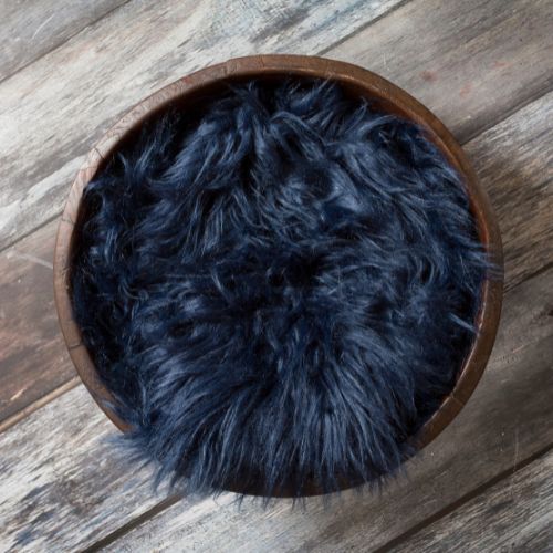 brown bowl on wooden flooring filled with black fluffy blanket