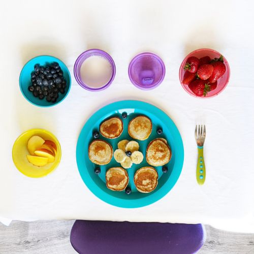 toddler plates and bowls with fruit and pancakes